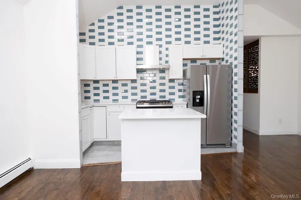 a kitchen with a refrigerator and a stove