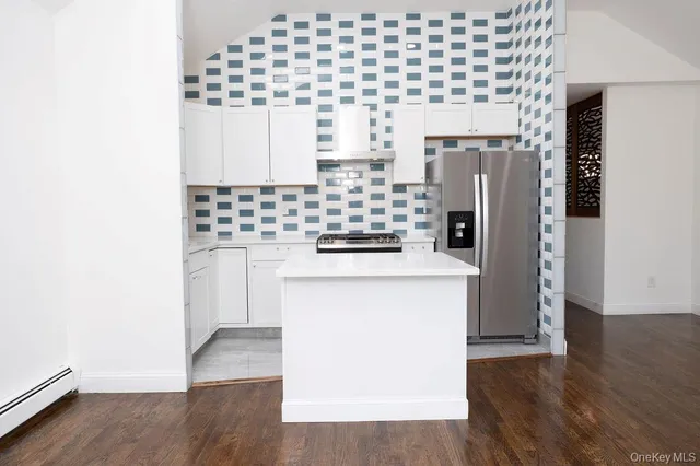 a kitchen with a refrigerator and a stove