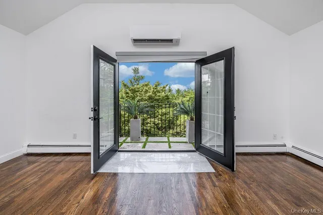 wooden floor in an empty room with a window