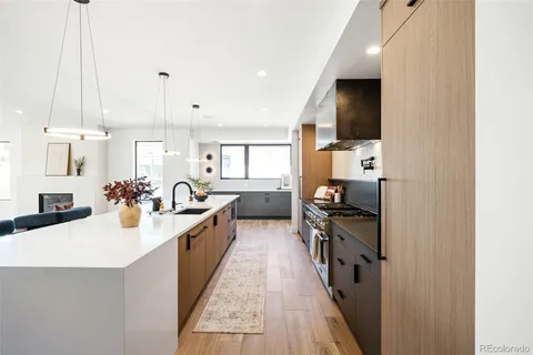 a kitchen with counter top space a sink and appliances