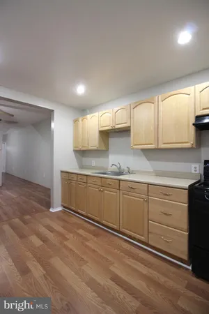 a kitchen with granite countertop a sink cabinets and stainless steel appliances