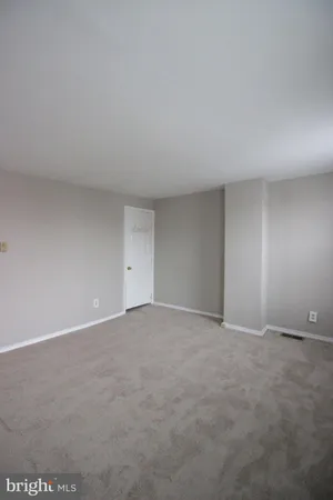 a view of an empty room and a window