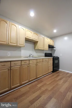 a kitchen with granite countertop white cabinets and stainless steel appliances