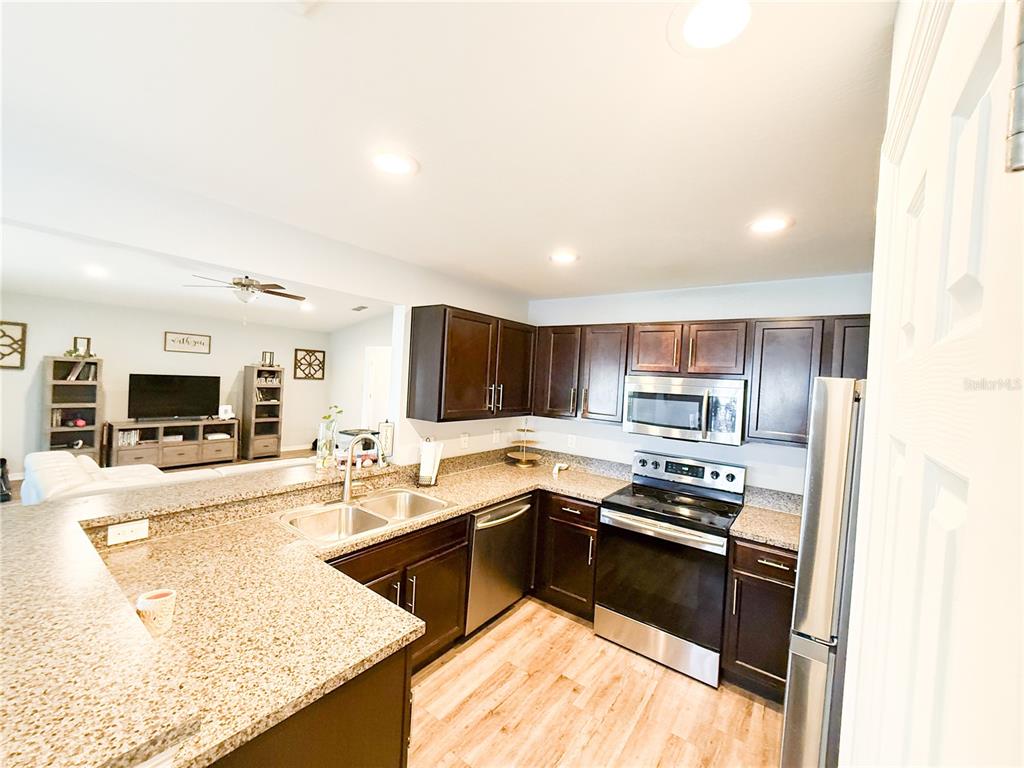 233 Cattail Way Lake Alfred, FL 33850 - Photo 11 of 25 a kitchen with kitchen island a sink appliances and cabinets