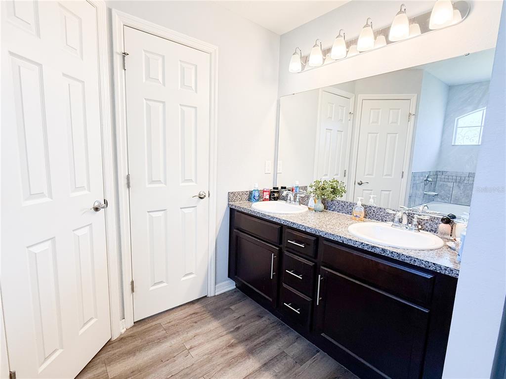 233 Cattail Way Lake Alfred, FL 33850 - Photo 13 of 25 a bathroom with a double vanity sink and a mirror