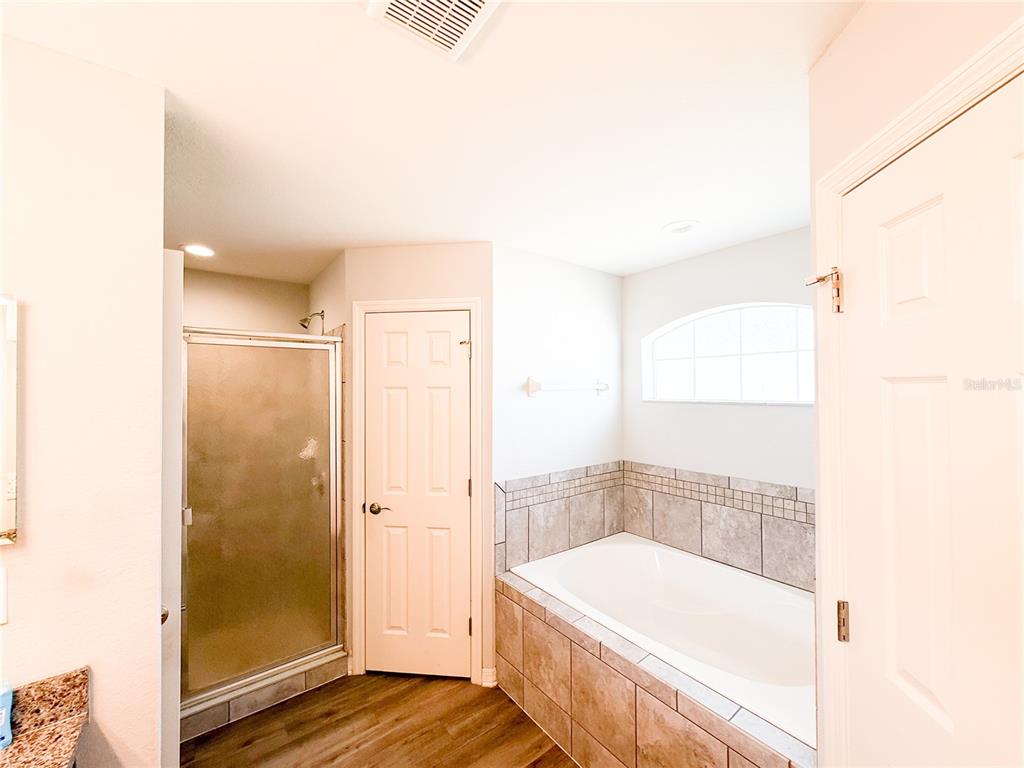 233 Cattail Way Lake Alfred, FL 33850 - Photo 14 of 25 a bathroom with a bathtub and shower