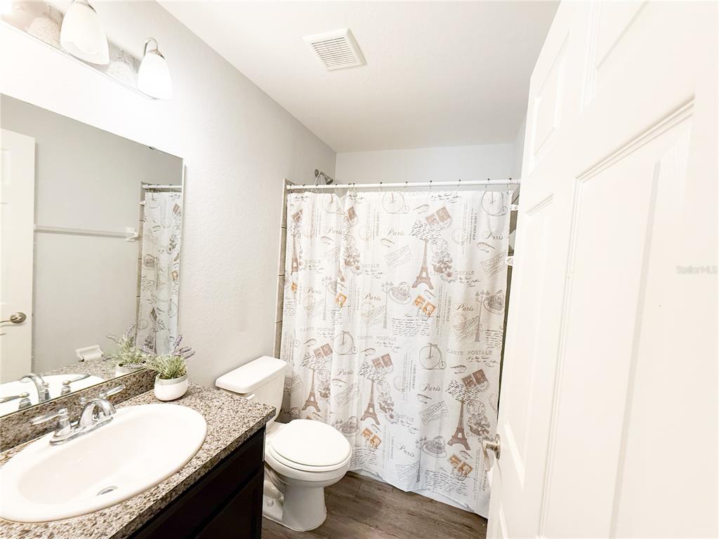 233 Cattail Way Lake Alfred, FL 33850 - Photo 18 of 25 a bathroom with a granite countertop sink toilet and a mirror