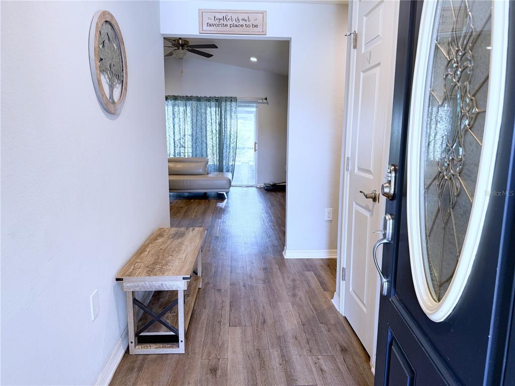 233 Cattail Way Lake Alfred, FL 33850 - Photo 4 of 25 a view of a hallway with wooden floor and a hallway