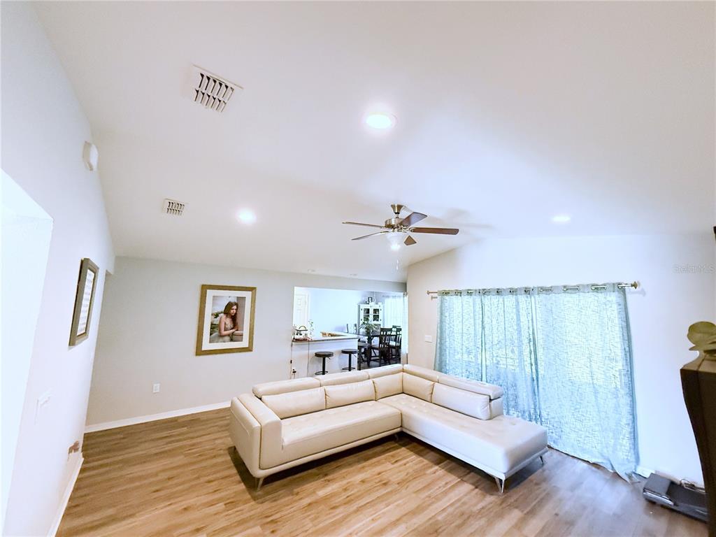 233 Cattail Way Lake Alfred, FL 33850 - Photo 5 of 25 a living room with furniture and a wooden floor