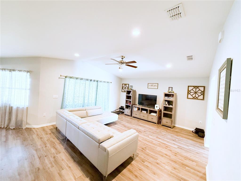 233 Cattail Way Lake Alfred, FL 33850 - Photo 6 of 25 a living room with furniture and a wooden floor