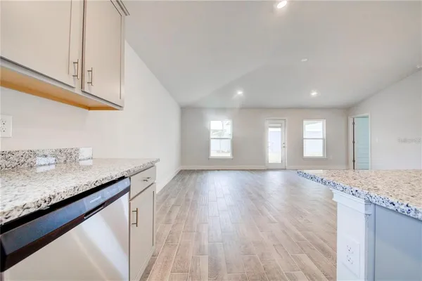 a view of a kitchen cabinets and wooden floor