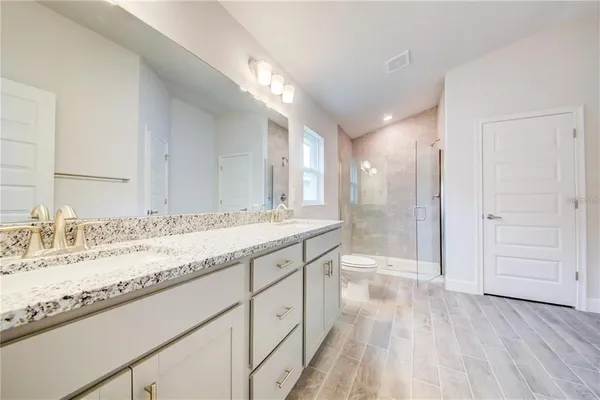 a bathroom with a granite countertop sink mirror and