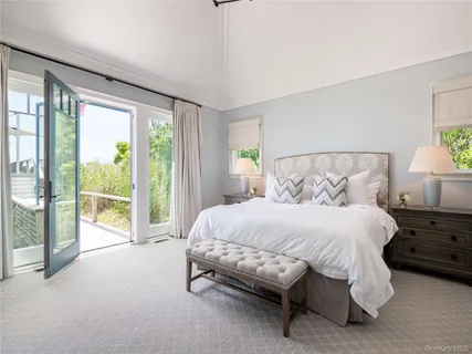 a spacious bedroom with a bed and a night stand