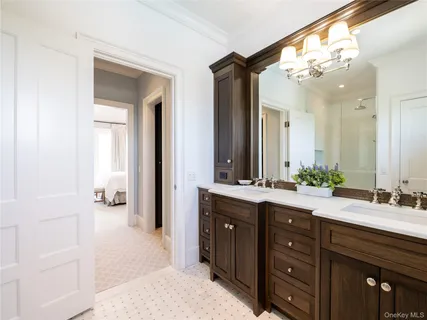 a spacious bathroom with a double vanity sink and a mirror