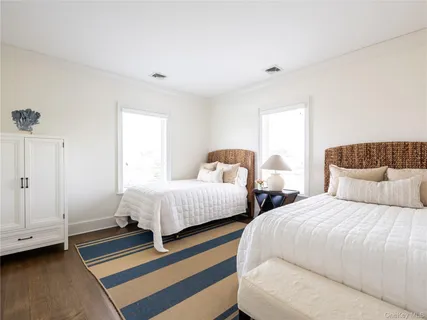 a bedroom with two beds and a couch
