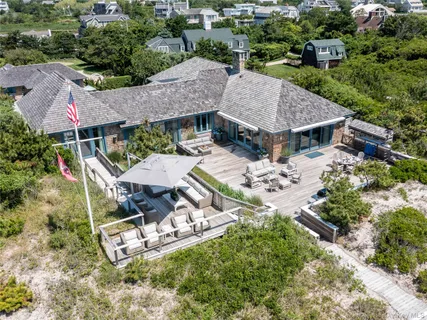 an aerial view of a house with table and chairs