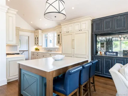 a kitchen with a center island appliances and cabinets