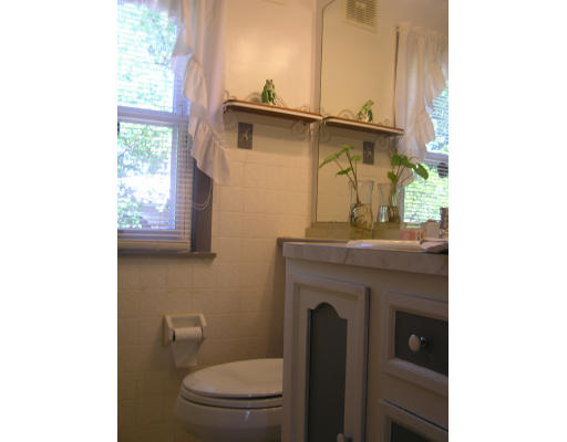 207 Prentice Street Springfield, MA 01104 - Photo 12 of 21 a bathroom with a toilet a sink and mirror