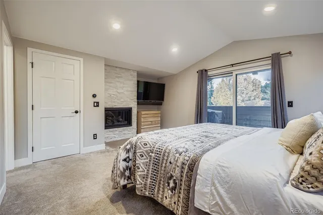 a spacious bedroom with a bed and a dresser