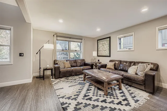 a living room with furniture and wooden floor