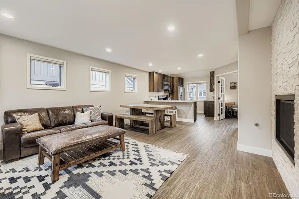 a living room with furniture and a wooden floor