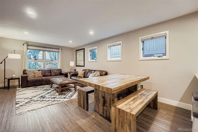 a living room with furniture a rug and a window