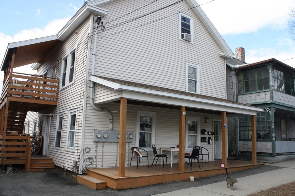 76 2nd Street Montague, MA 01376 - Photo 1 of 8 a front view of a house with glass windows and furniture