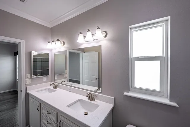 a bathroom with a double vanity sink and a mirror