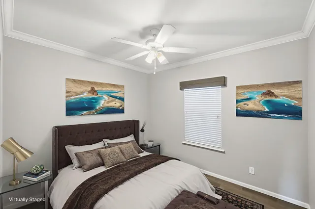 a bedroom with a bed and a painting on the wall