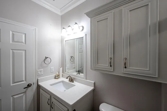a bathroom with a sink vanity and mirror