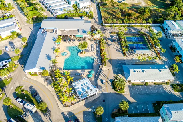 an aerial view of residential houses and car parked