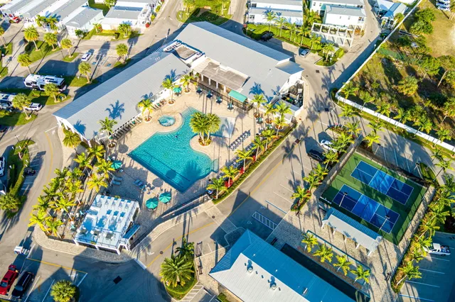 a view of multiple houses with swimming pool