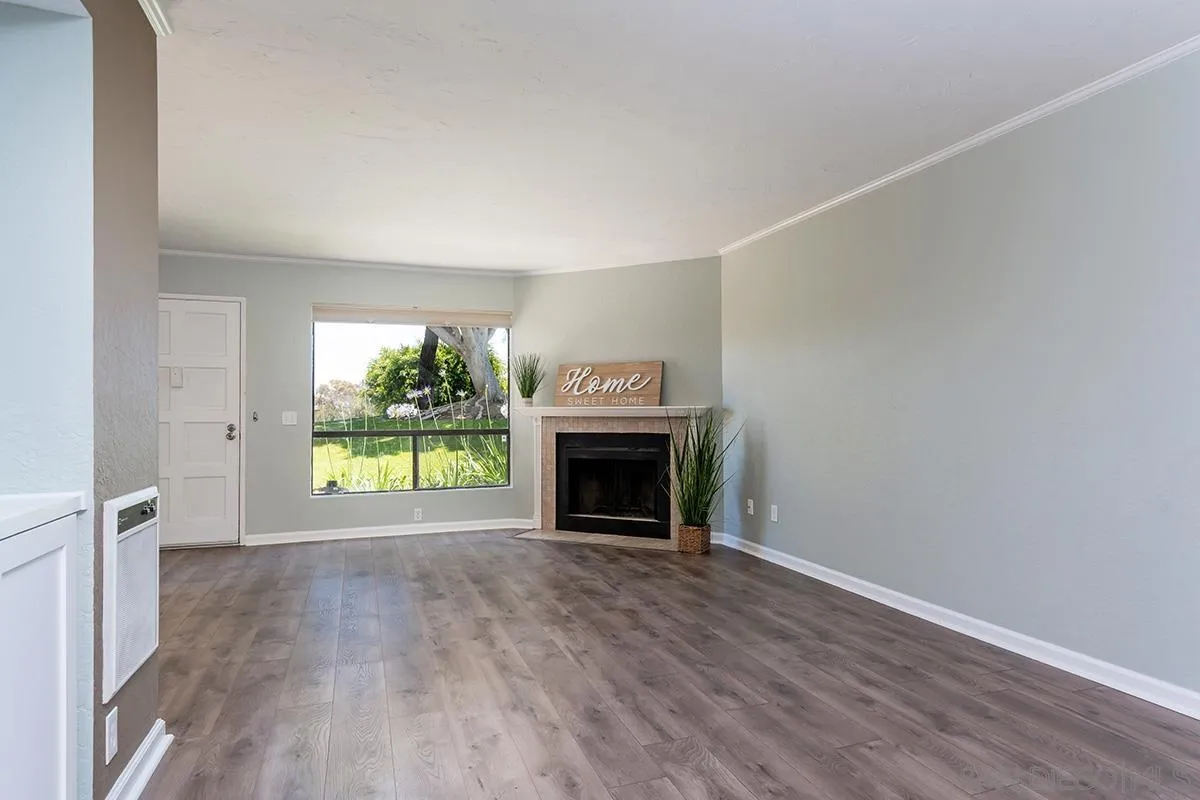 705 Copper Drive Vista, CA 92083 - Photo 11 of 31 an empty room with fireplace and windows