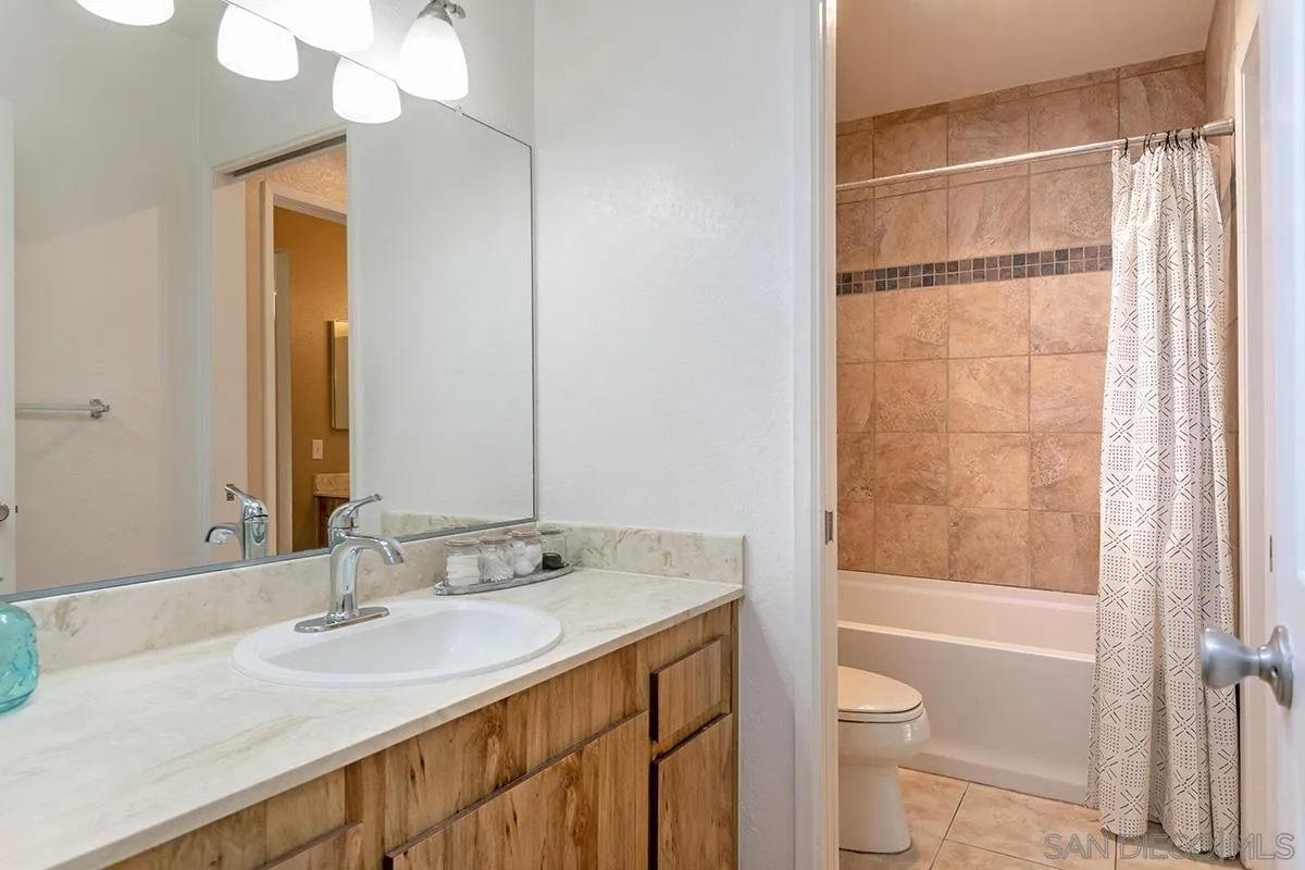 705 Copper Drive Vista, CA 92083 - Photo 17 of 31 a bathroom with a sink a toilet and shower