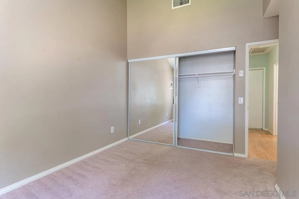 705 Copper Drive Vista, CA 92083 - Photo 20 of 31 an empty room with closet and wooden door