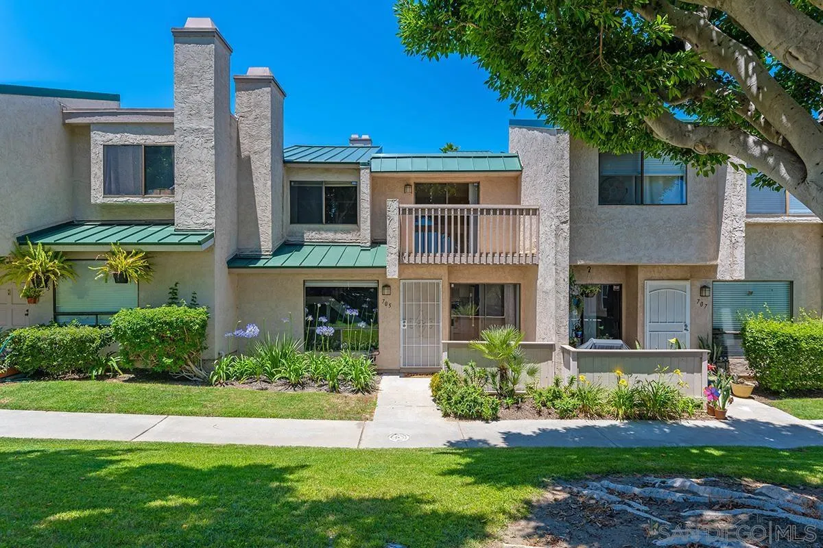 705 Copper Drive Vista, CA 92083 - Photo 23 of 31 a front view of a house with a yard and garage
