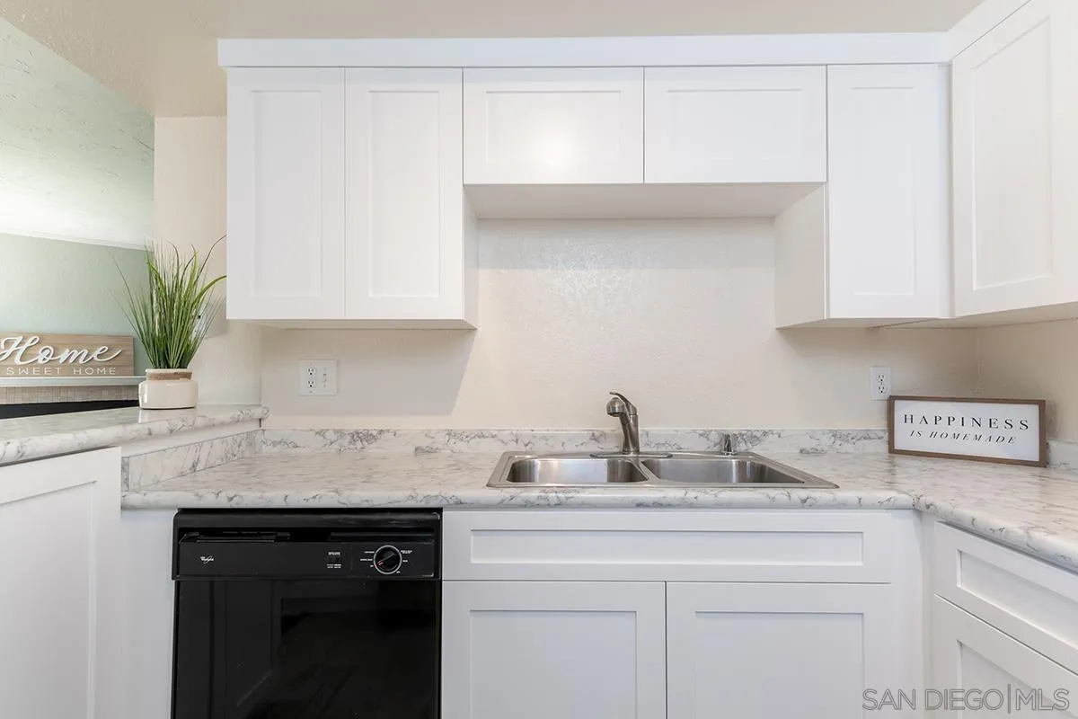 705 Copper Drive Vista, CA 92083 - Photo 4 of 31 a kitchen with appliances a sink and cabinets