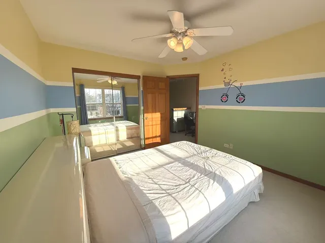 a bedroom with a bed mirror and a window