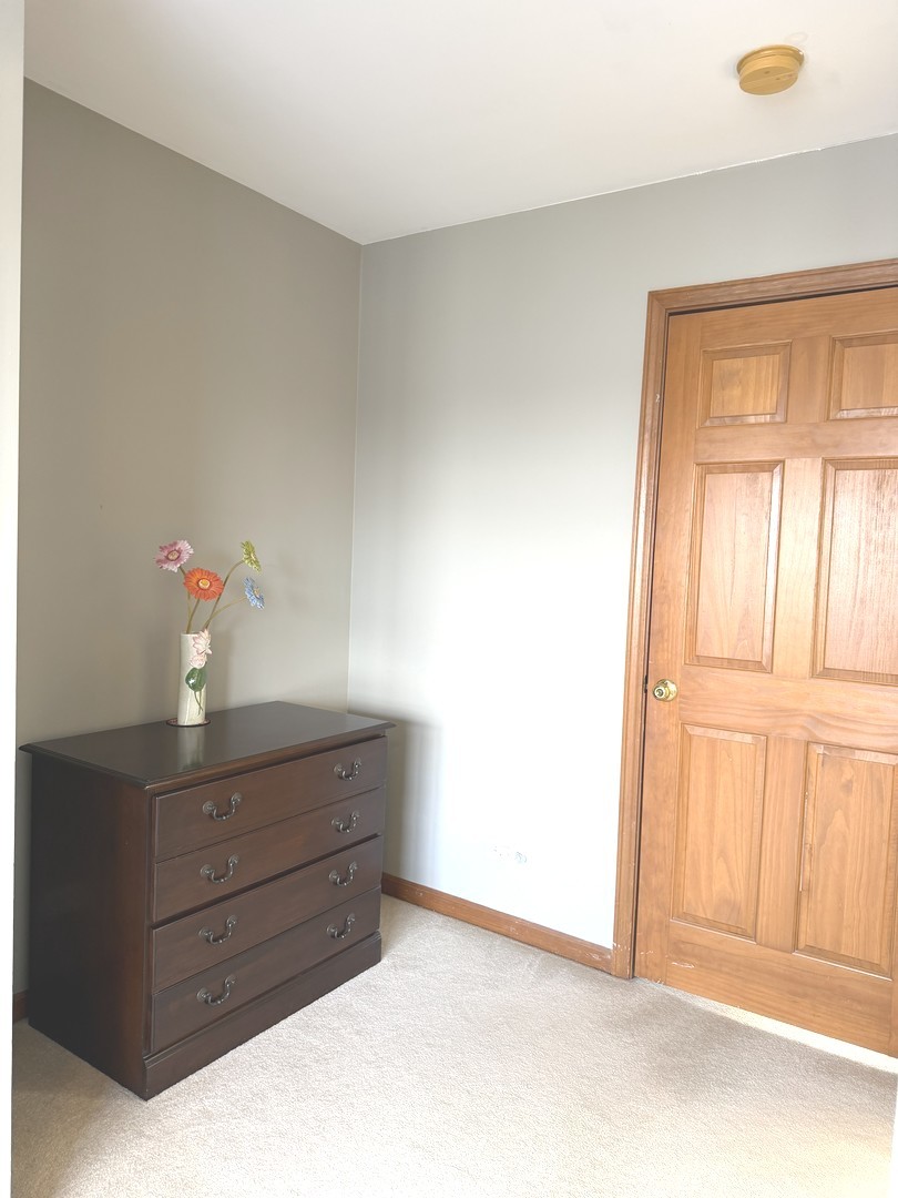 864 Genesee Drive Naperville, IL 60563 - Photo 18 of 31 a room with a dresser and a window