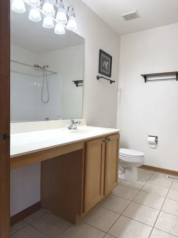 a bathroom with a sink a toilet and mirror