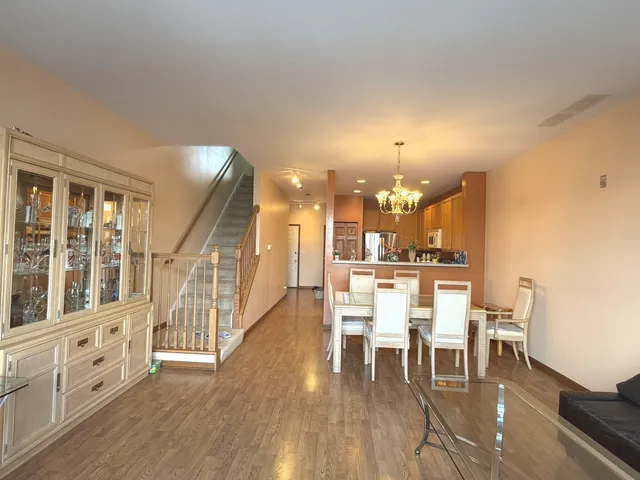 a view of a a dining room with furniture window and wooden floor