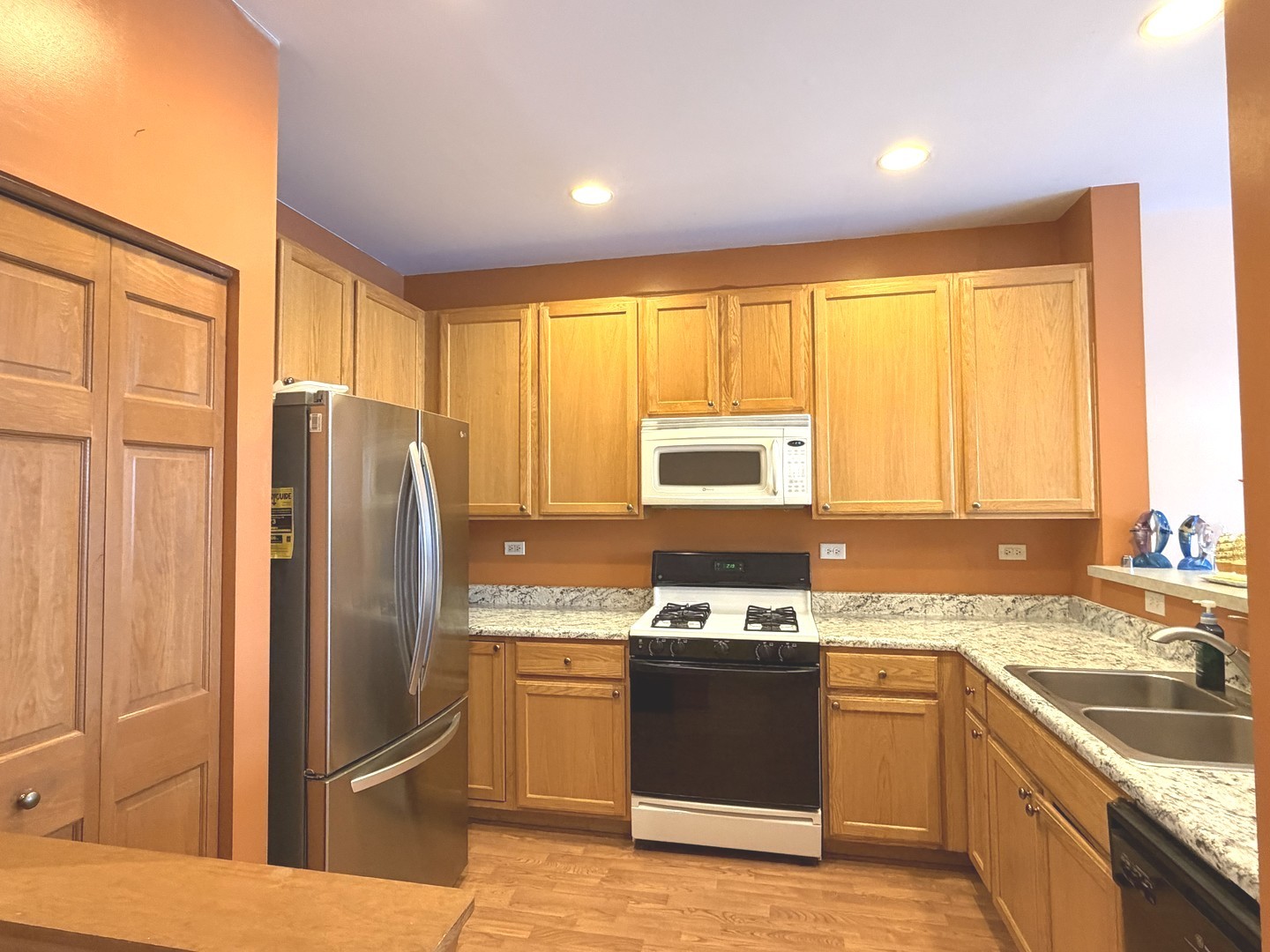 864 Genesee Drive Naperville, IL 60563 - Photo 5 of 31 a kitchen with stainless steel appliances granite countertop a refrigerator a sink a stove and island