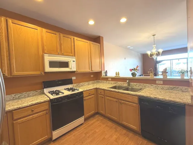 a kitchen with stainless steel appliances granite countertop stove top oven and sink