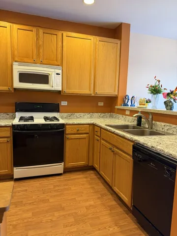 a kitchen with appliances cabinets and a sink