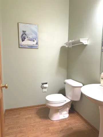 a white toilet sitting next to a bathroom sink and vanity