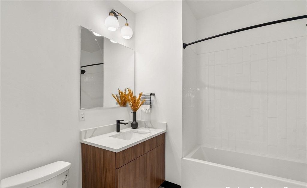 600 Broadway, Unit 509 Chelsea, MA 02150 - Photo 2 of 21 a bathroom with a sink toilet and shower