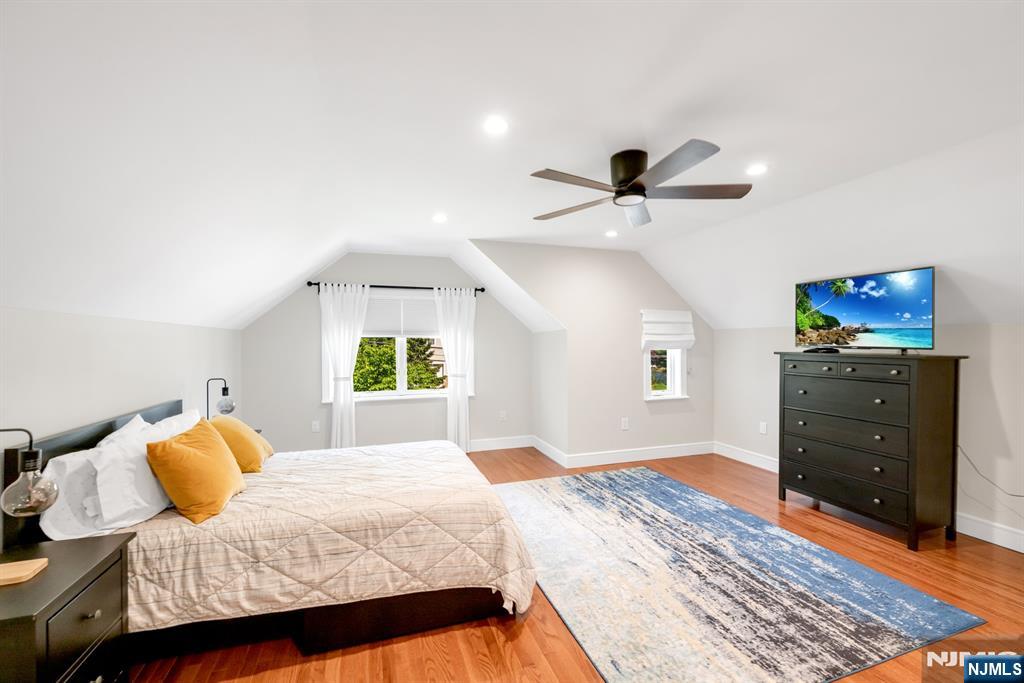433 Piermont Road Cresskill, NJ 07626 - Photo 28 of 49 a bedroom with a bed and a chandelier