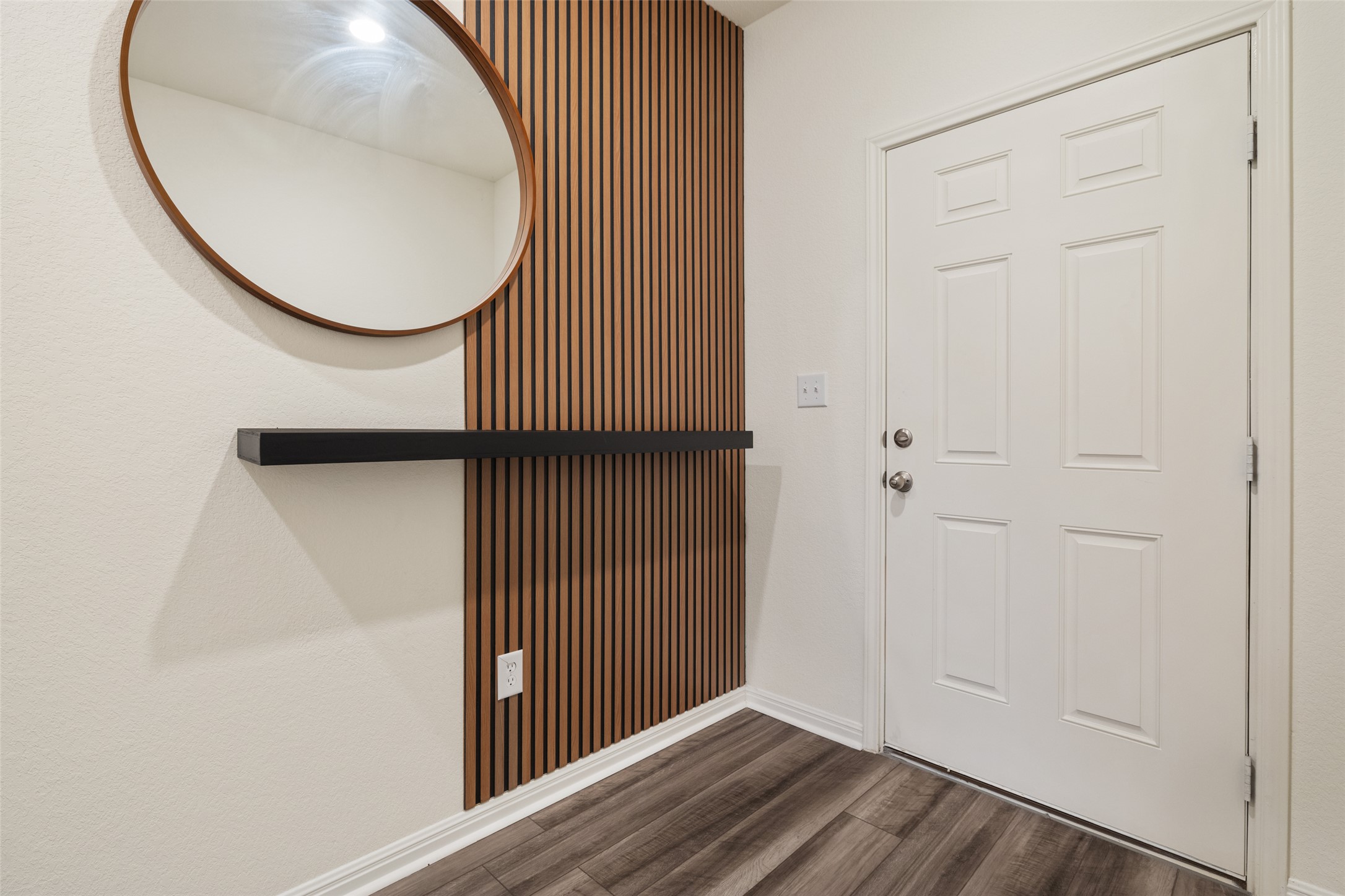 261 Night Riders Way Jarrell, TX 76537 - Photo 3 of 6 A welcoming entryway with a contemporary slat wall accent and durable flooring creates a polished first impression.