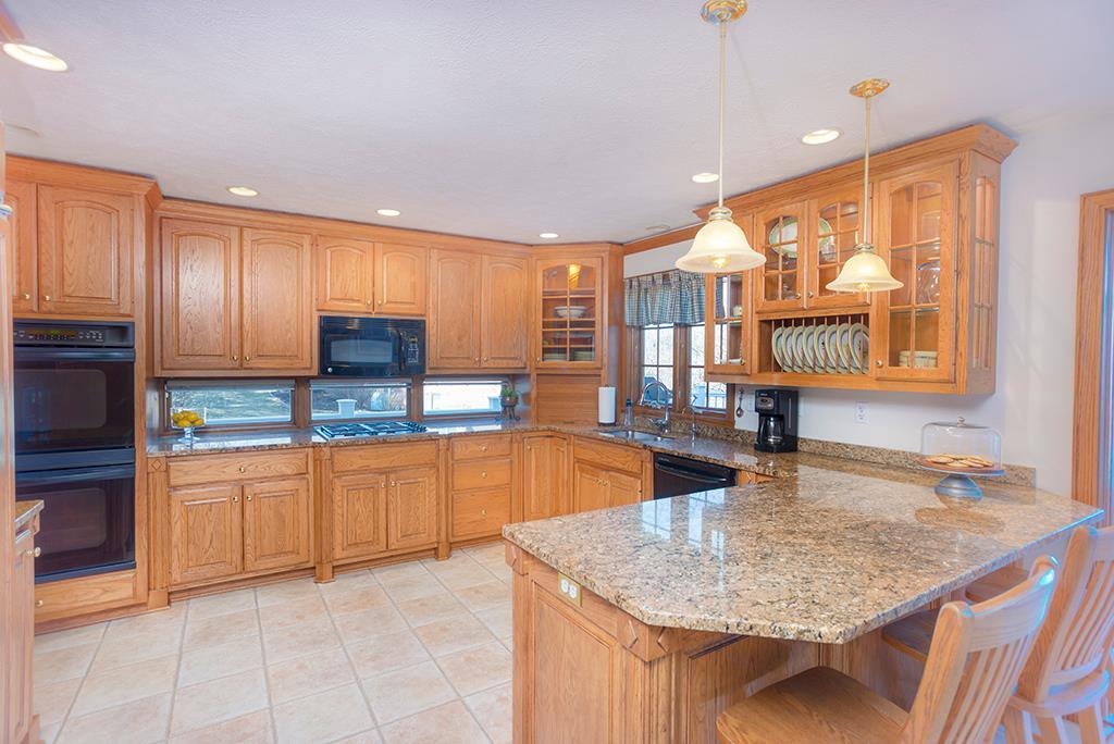 966 Spring Ridge Court Belvidere, IL 61008 - Photo 11 of 44 a kitchen with stainless steel appliances granite countertop a sink and a white cabinets