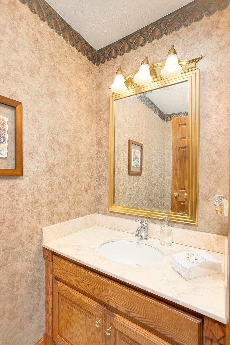 966 Spring Ridge Court Belvidere, IL 61008 - Photo 18 of 44 a bathroom with a sink and a mirror